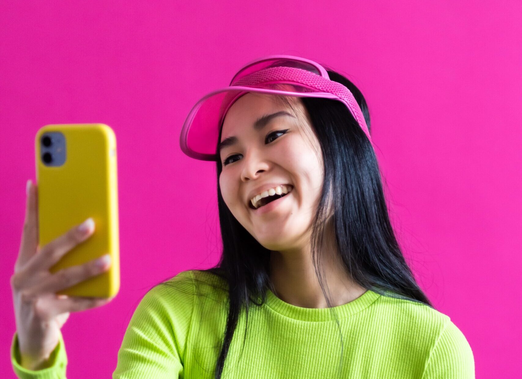 Asian girl laughing at her phone