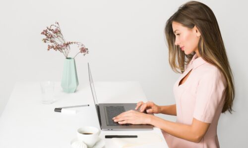 woman typing on her laptop
