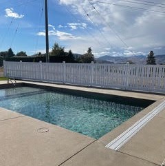 white picket style fence around pool