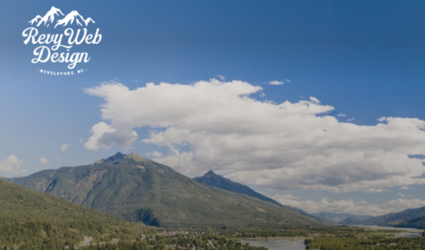 Picture of summer mountains in Revelstoke with Revey Web Design logo in top left-hand corner