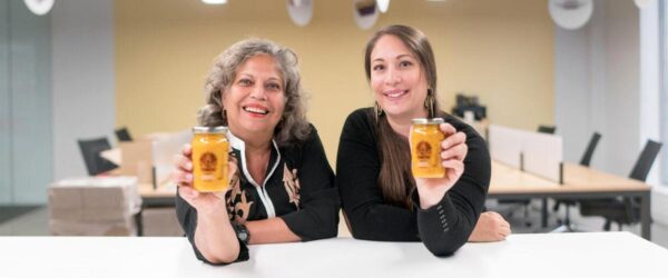 mother and daughter team, co-founders on Naledo holding their product jars and smiling