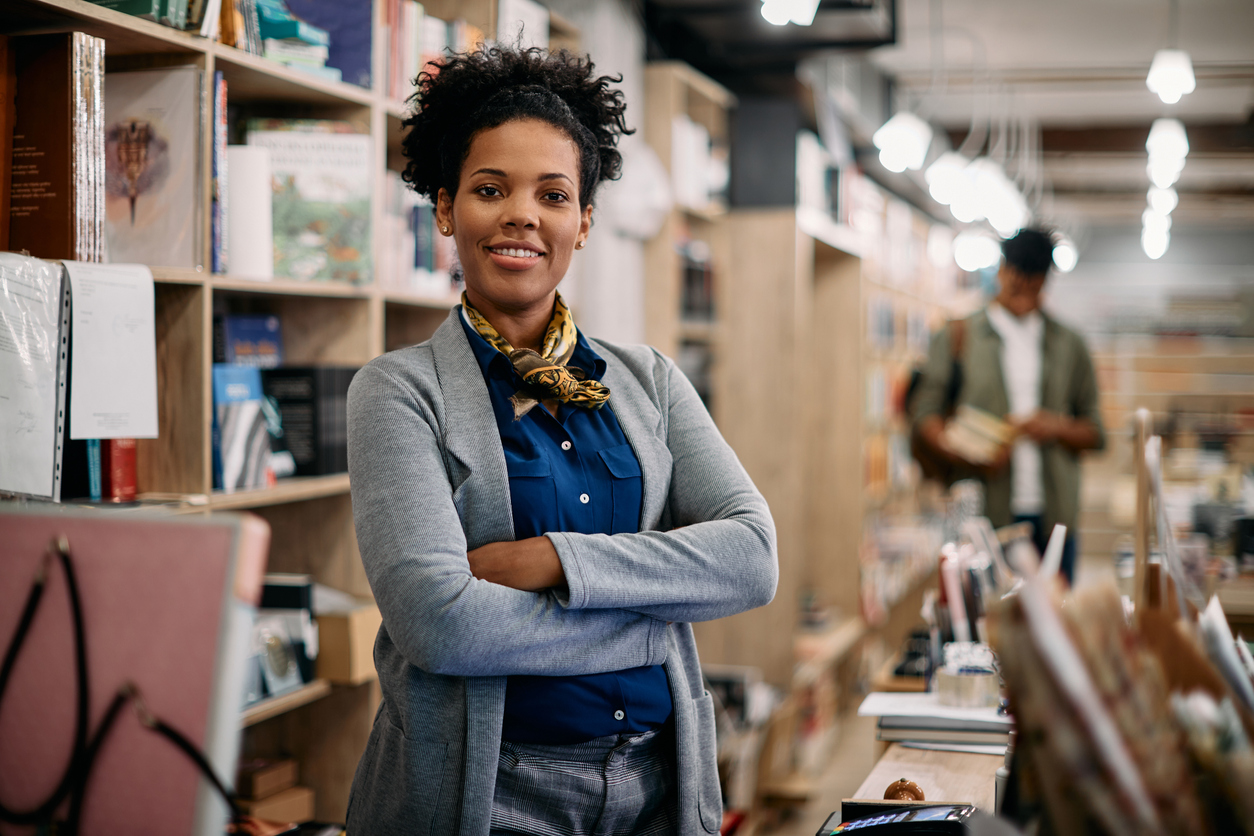 Confident woman business owner with her arms crossed thinks about her entrepreneurial mindset