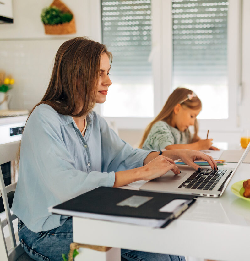Woman participating in webinar with kid beside her