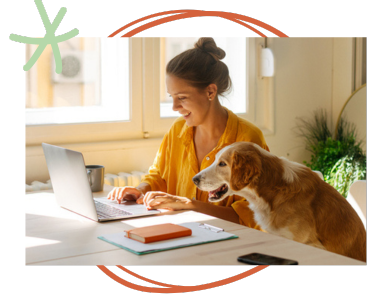 Woman business owner working on laptop with dog